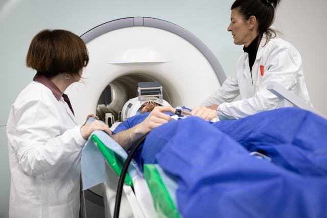 <p>A volunteer takes part in an MRI exam simulation</p>