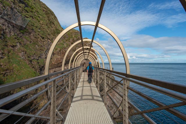 <p>The three-mile Gobbins Cliff Walk allows visitors to walks next to the basalt cliffs over the Irish Sea</p>