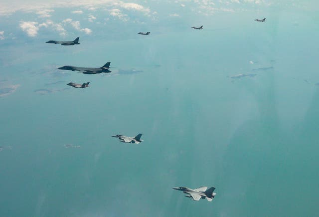 <p>Two US Air Force B-1B bomber, top left, flies over the Korean Peninsula with South Korean Air Force F-35A fighter jet, F-16 fighter jets and US Air Force F-16 fighter jets in South Korea during the joint aerial drills of South Korea and the United States, at an undisclosed location in South Korea</p>