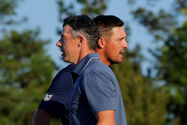 <p>Rory McIlroy shakes hands with Bryson DeChambeau</p>