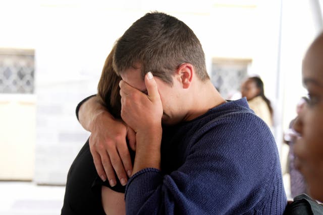 <p>A relative hugs Belgian national Seppe Lodewijckx</p>