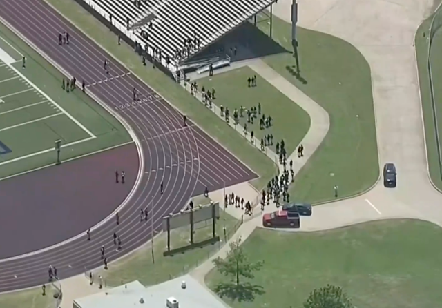 <p>Students at Wilmer-Hutchins High School in Dallas, Texas evacuate after a shooting incident</p>