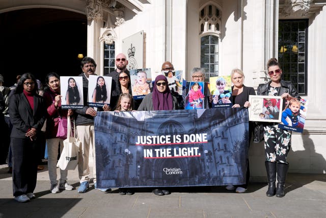 Supporters outside court, including Lanre Haastrup, the father of Isaiah Haastrup; and Aliya Abbasi and Rashid Abbasi, the parents of Zainab Abbasi (Lucy North/PA)