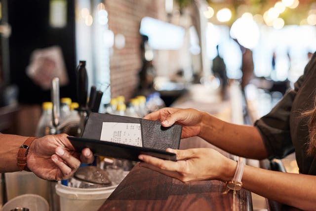 <p>Hands with bill, food service and people in restaurant, customer with receipt and payment with cashier or waiter. Fine dining, dinner and check at cafe, catering and hospitality with finance</p>