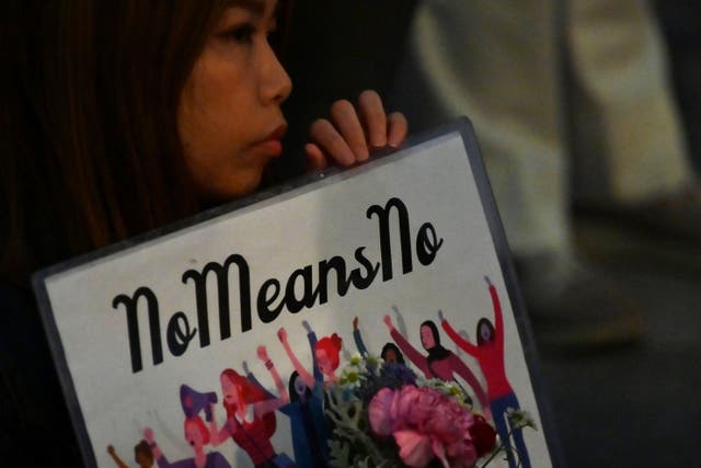 <p>A demonstrator holds a placard during a protest against the lack of substantial legal protection for sexual assault victims in Tokyo on 11 June 2019</p>