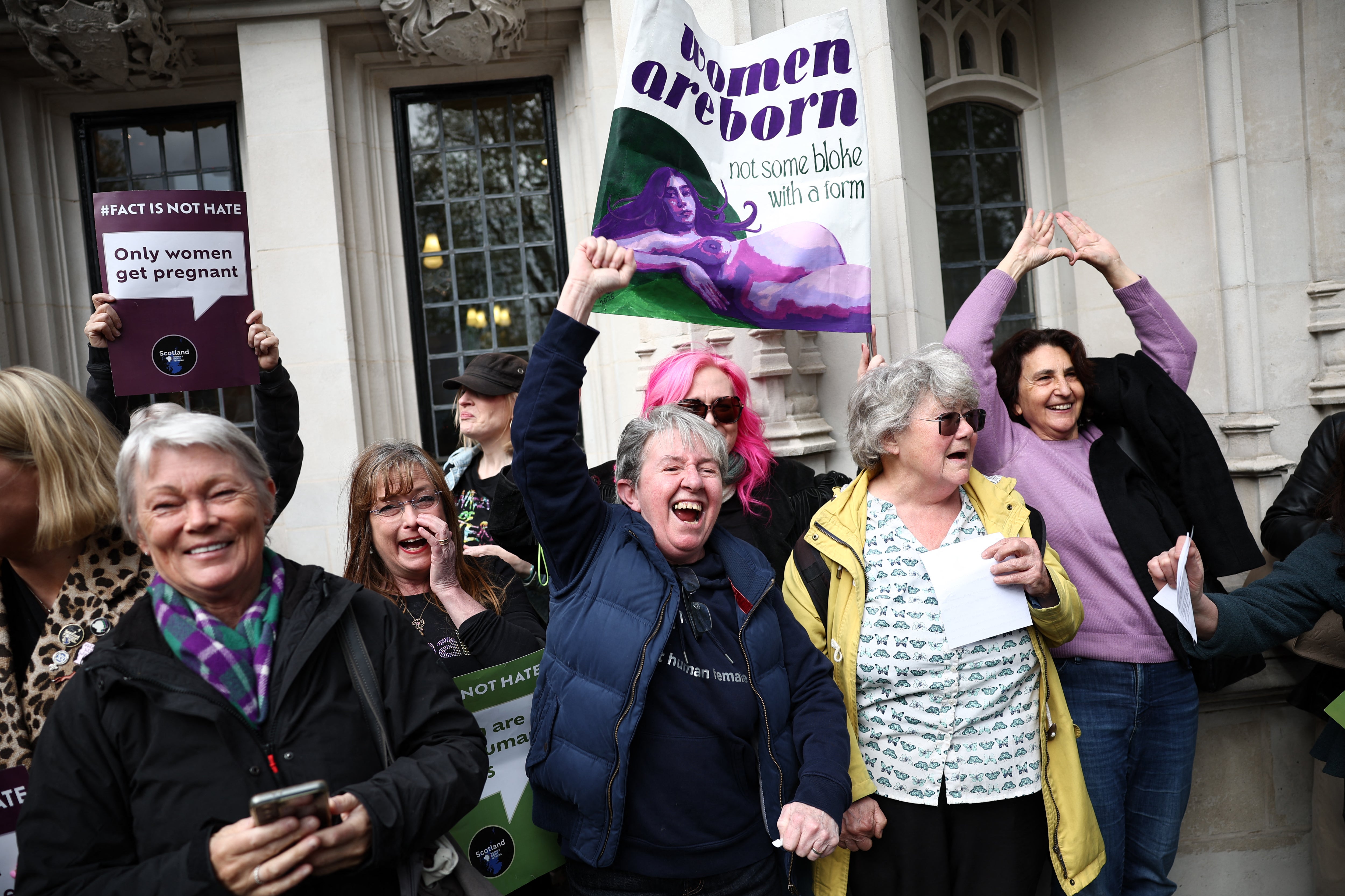 Activists celebrate after hearing the outcome of the Supreme Court's ruling on how to define a 'woman', in London on April 16, 2025
