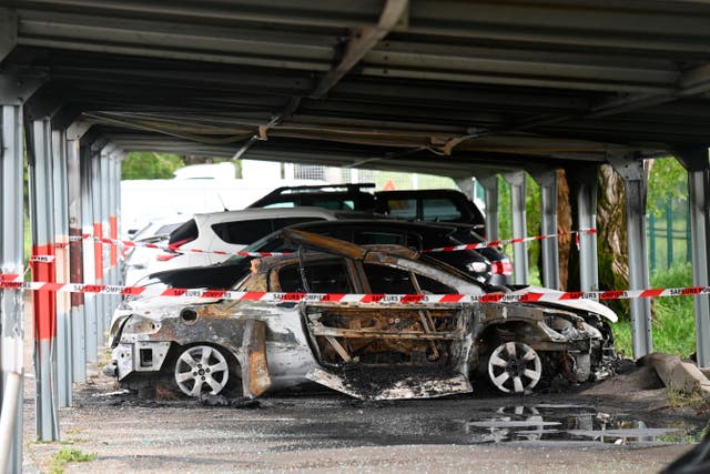 <p>A burned car in front of the Tarascon prison in Tarascon, southern France</p>