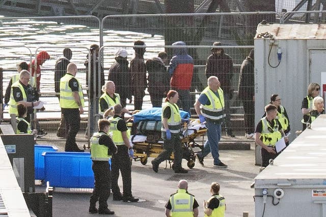 Stretcher of equipment is wheeled through the Border Force compound as a group of people thought to be migrants are brought in to Dover, Kent, from a Border Force vessel (Gareth Fuller/PA)