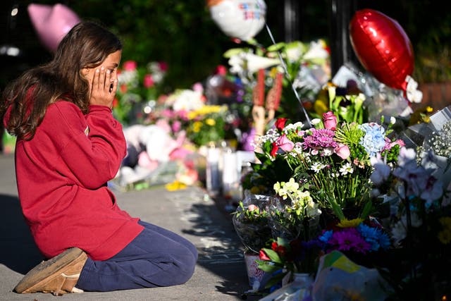 <p> Student honors the deceased and injured students near the scene of a shooting at the Florida State University student center on April 18</p>