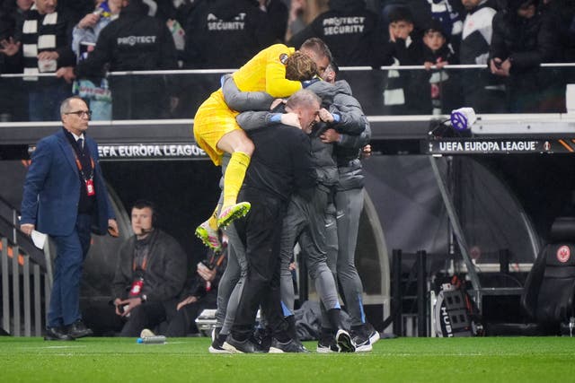 Guglielmo Vicario jumps on Tottenham boss Ange Postecoglou and his coaching staff at full-time after a 1-0 win over Eintracht Frankfurt (Bradley Collyer/PA)