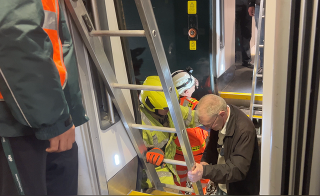 <p>Safety first: rail staff help passengers transfer from a stricken GWR train to a replacement</p>