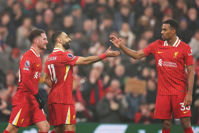 <p>Mohamed Salah of Liverpool, centre, celebrates with teammates Alexis Mac Allister (left) and Ryan Gravenberch (right)) during the Premier League match between Liverpool FC and Leicester City FC at Anfield on Boxing Day 2024</p>