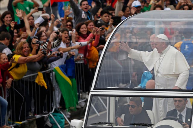 <p>Pope Francis waves from the popemobile as he rides along the Copacabana beachfront on his way to celebrate mass for World Youth Day, in Rio de Janeiro, Brazil, Sunday, July 28, 2013. (AP Photo/Silvia Izquierdo, File)</p>