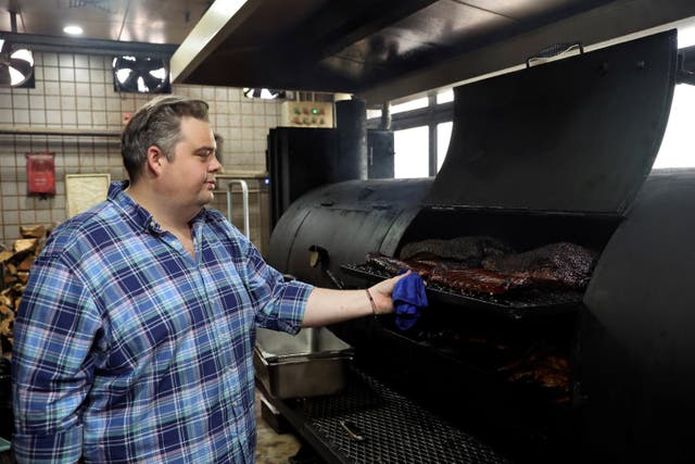 <p>Charles de Pellette, Operations Director of the restaurant, poses for a picture next to U.S. beef and pork in a smokehouse, at Home Plate BBQ, an American-style restaurant, in Beijing, China April 17, 2025. REUTERS/Tiffany Le</p>