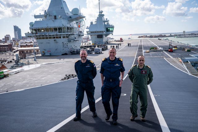 <p>Captain Will Blackett RN, Commanding Officer of HMS Prince of Wales, left, Commodore James Blackmore RN, Commander Carrier Strike Group, centre, and Captain Colin McGannity RN, Commander Air Group, right, onboard HMS Prince of Wales docked at HM Naval Base Portsmouth, as they prepare the carrier ahead of it deploying as part of the UK Carrier Strike Group to conduct interoperability training and defence engagement in the Indo-Pacific. Picture date: Wednesday April 16, 2025</p>