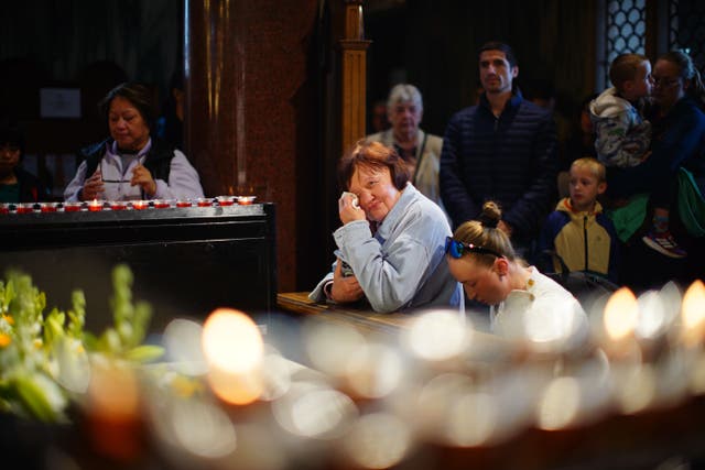 People in Westminster Cathedral following the announcement by the Vatican of the death of Pope Francis aged 88 (James Manning/PA)
