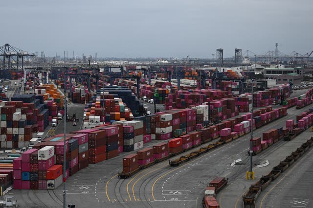 <p>Shipping containers sit stacked on trains at the Port of Los Angeles. An expert says if Donald Trump’s tariff plan continues, the U.S. will ‘absolutely’ enter a recession</p>