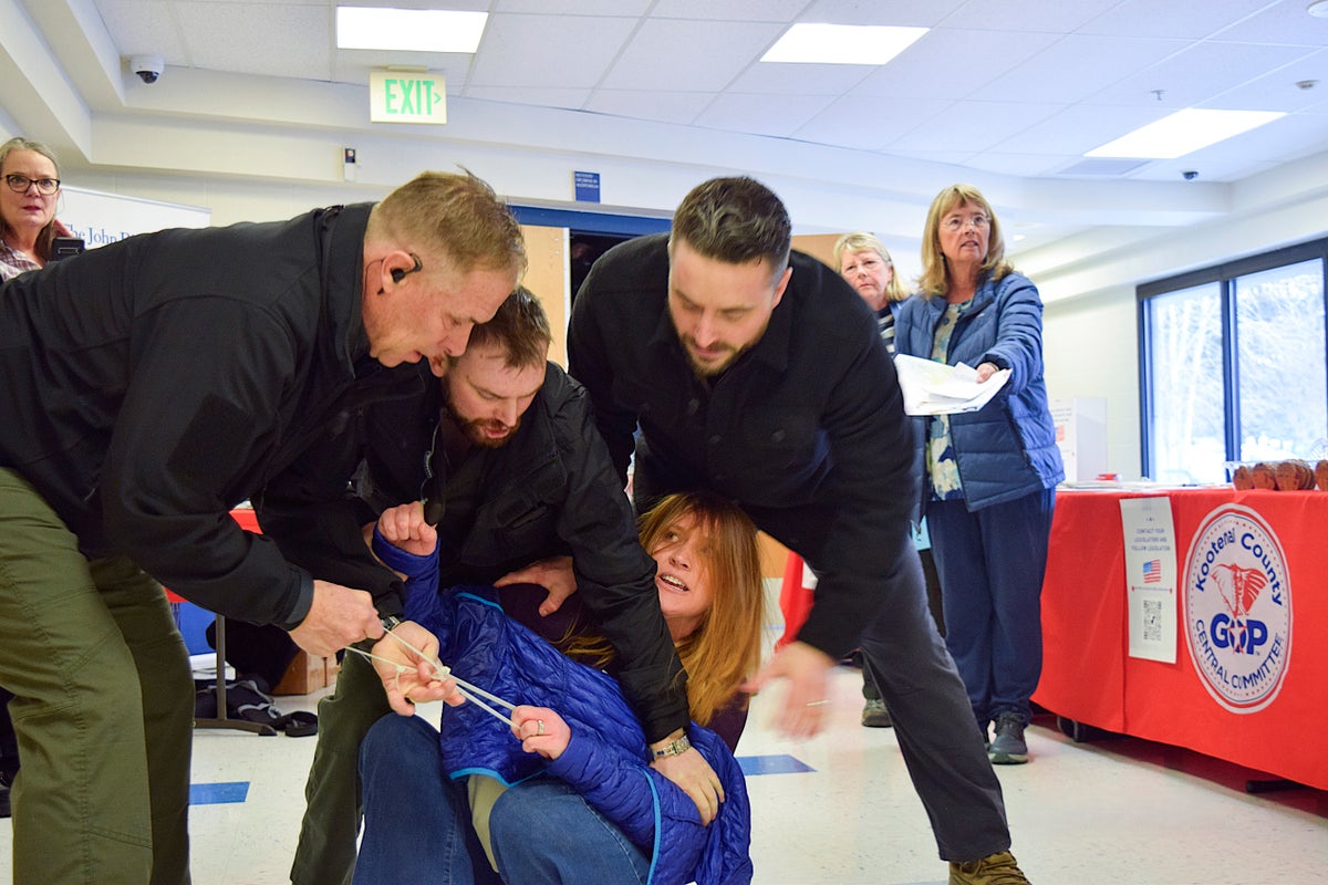 6 security guards charged after woman’s removal from Republican town hall