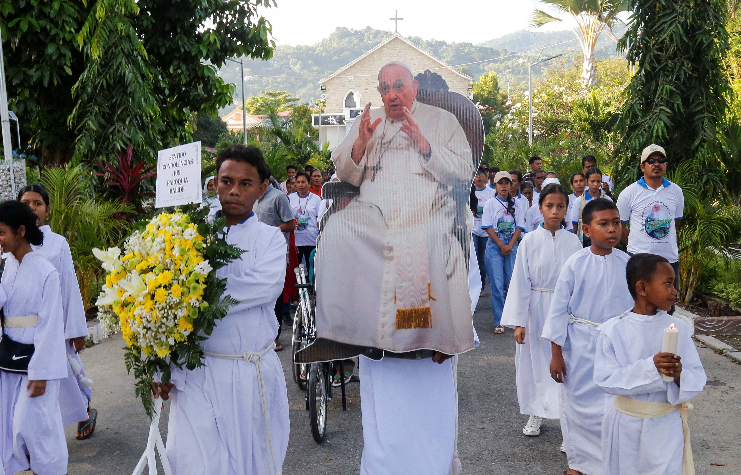 Timorese Catholics carry a cut-out of Pope Francis during a procession ahead of a prayer service, following his death, in Dili, East Timor