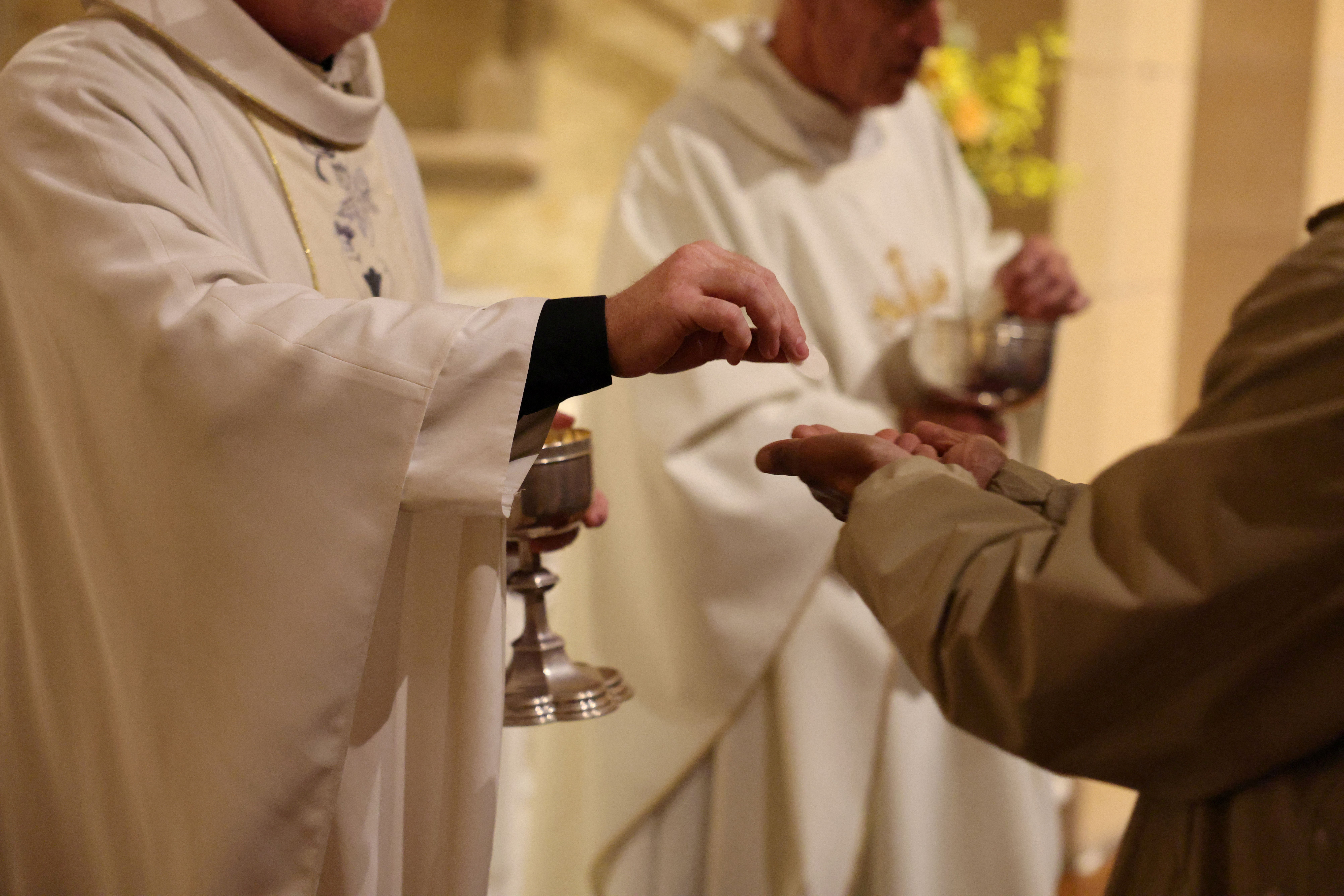 People receive communion during Requiem Mass Sydney