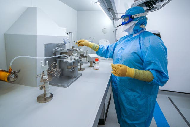 Staff work inside the AstraZeneca Laboratory in Macclesfield (Peter Byrne/PA)