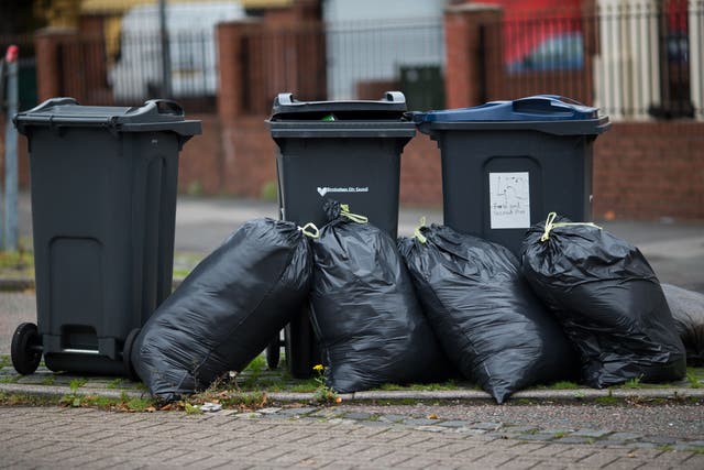 Rubbish bags piled up in front of bins in Birmingham (Aaron Chown/PA)