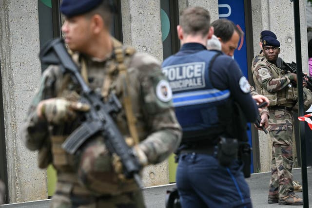 <p>French military and police officers stand outside the high school Notre-Dame de Toutes-Aides where a student allegedly killed another teen and wounded three others in a knife attack</p>
