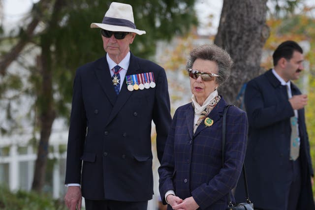 The Princess Royal, president of the Commonwealth War Graves Commission, and Vice Admiral Sir Tim Laurence at the grave in Sedd el Bahr of Lieutenant Colonel Charles Doughty-Wylie VC of the Royal Welch Fusiliers (Yui Mok/PA)