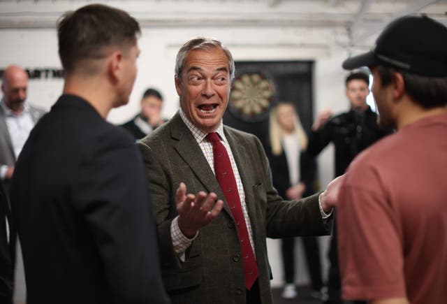 <p>Leader of Reform UK party Nigel Farage talks to boxers at the Boxclub gym in Hull, Britain, 25 April 2025</p>