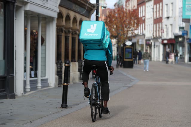 A Deliveroo rider on Worcester High Street (PA)