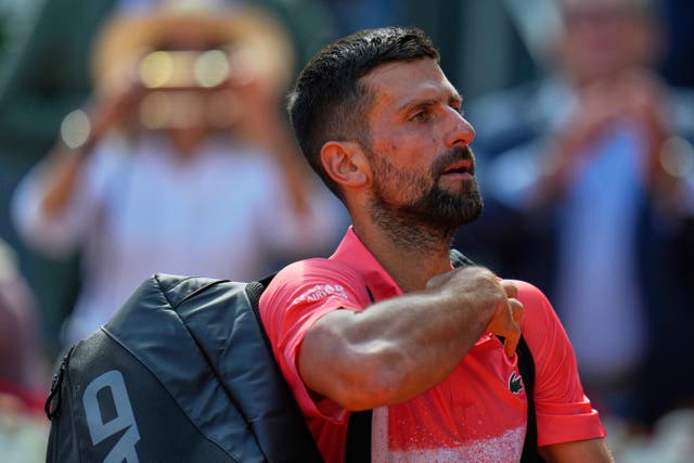 Novak Djokovic leaves the court after losing to Matteo Arnaldi (Manu Fernandez/AP)