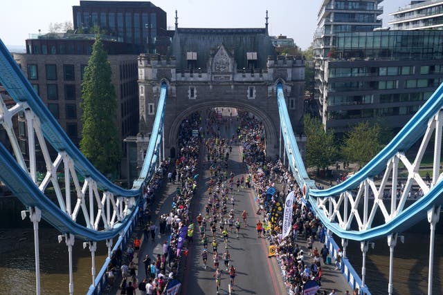 Runners in the mass participation race on Tower Bridge during the TCS London Marathon (Jonathan Brady/PA)