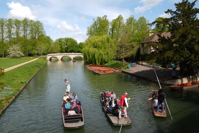 People enjoy the warm weather as they punt along the River Cam in Cambridge (Joe Giddens/PA)