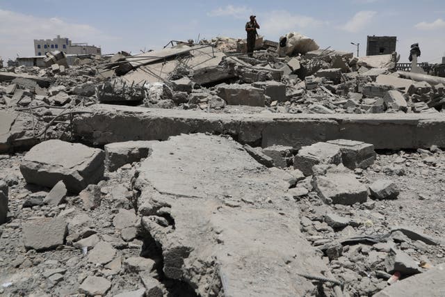 <p>A Yemeni soldier inspects the damage reportedly left by a US air strike</p>