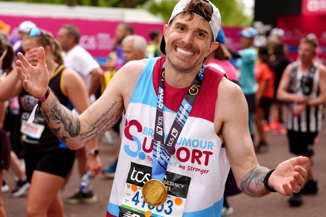 Joel Dommett after crossing the finish line during the TCS London Marathon (John Walton/PA)