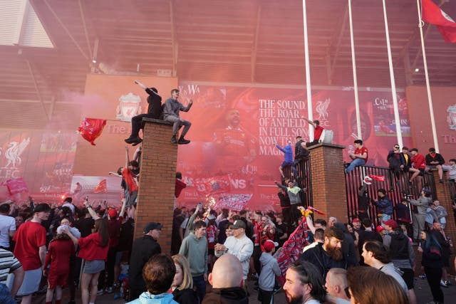 Liverpool fans celebrate victory in the Premier League at Anfield (Martin Rickett/PA)