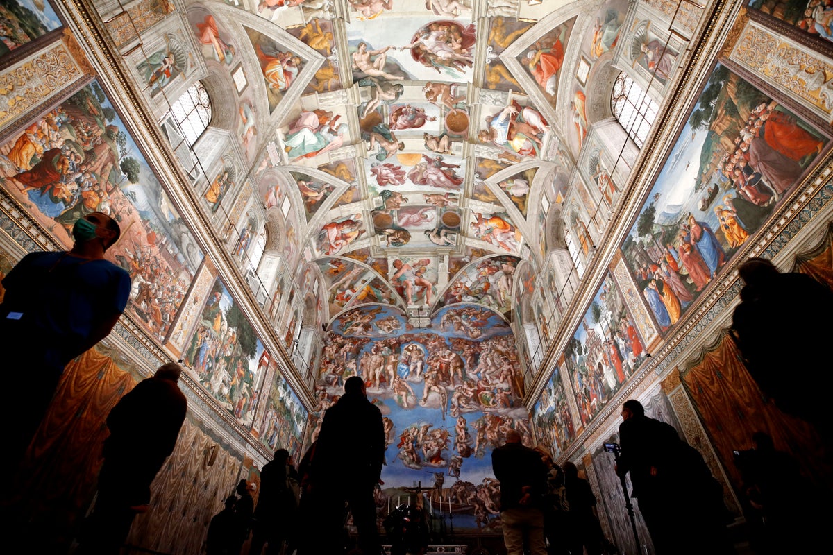 Vatican firefighters install a chimney on the roof of the Sistine Chapel for the papal election