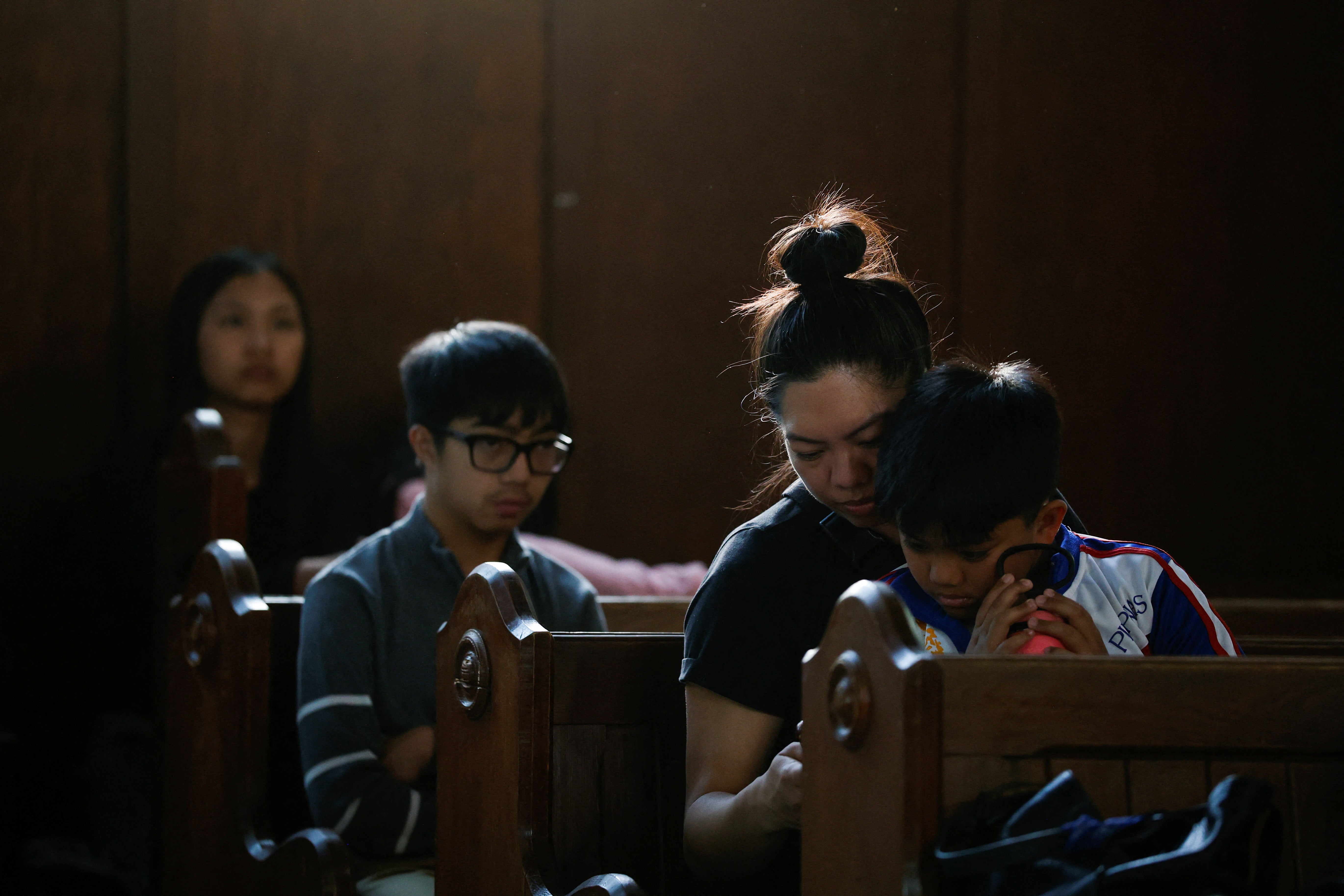 Members of the Filipino community mourn at St Mary the Virgin South Hill Church