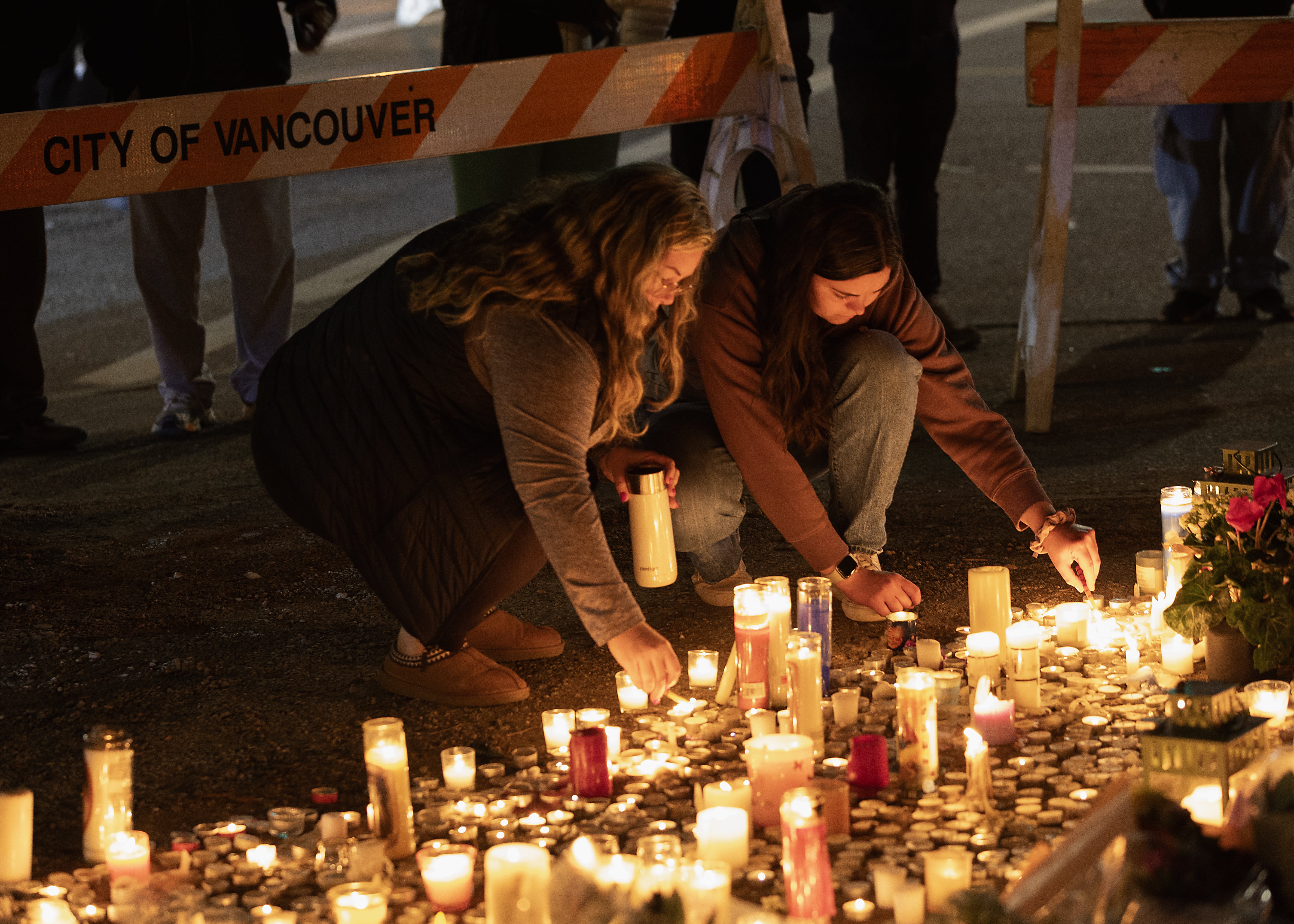 People attend the candlelight vigil near the scene of the car ramming attack