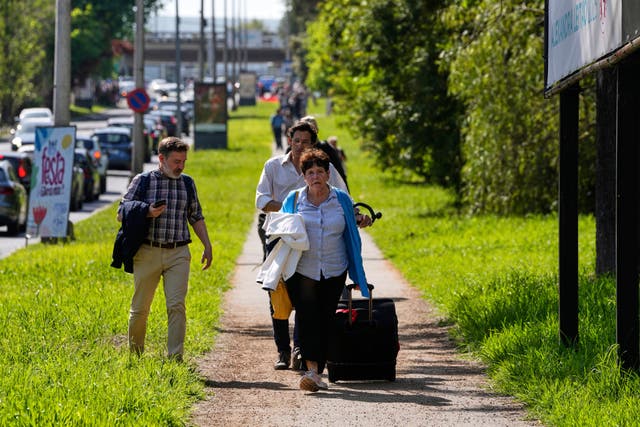 <p>Long haul: Passenger walking to Lisbon airport during the power outage</p>