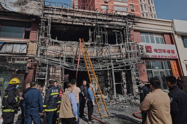 <p>Firefighters and officials survey the site of a restaurant fire in Liaoyang, northeastern China's Liaoning province, on Tuesday, April 29, 2025</p>