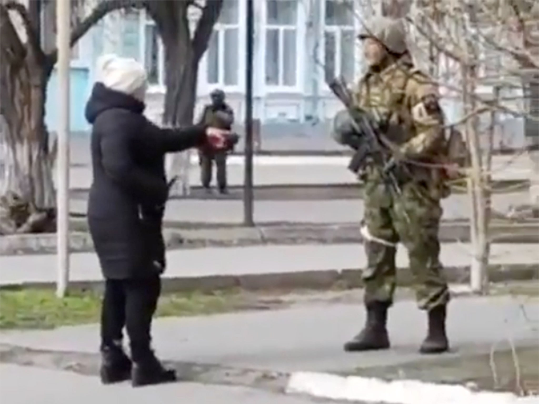 A Ukrainian woman confronts Russian soldier in Henichesk during the first days of the invasion in March 2022