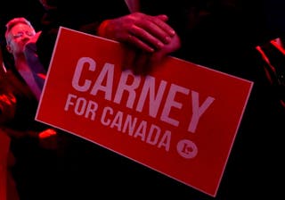 A supporter of Canada's prime minister Mark Carney holds a sign at the Liberal Party election night headquarters in Ottawa, Ontario, Canada 28 April 2025