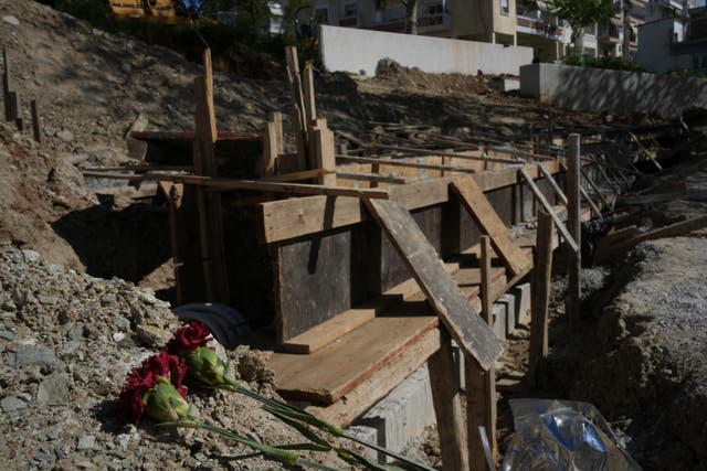 <p>Flowers lie at the site where mass graves containing remains believed to have belonged to dozens of prisoners executed during or after the Greek Civil War were uncovered in Thessaloniki, Greece, Friday, April 11, 2025. (AP Photo/Thanassis Stavrakis)</p>