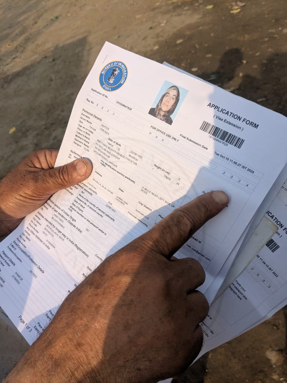 Ghulam Masoor shows his spouse's visa documents that are valid until September 2026
