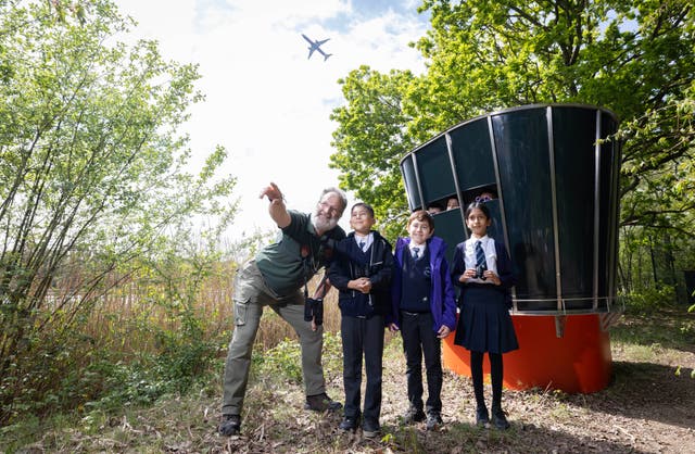 <p>Biodiversity Manager at Heathrow Airport, Adam Cheeseman, and local school kids Subhan, Sarrah and Amin at a new Nature Traffic Control Tower, a birdwatching hideaway designed to resemble Heathrow's control tower</p>