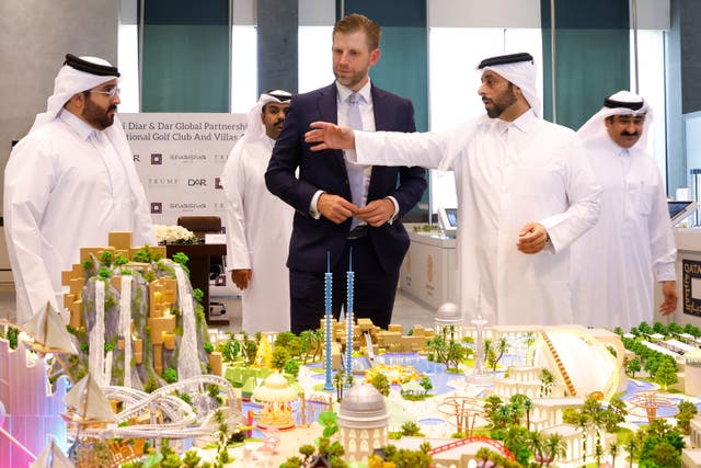 <p>Eric Trump, executive vice president of the Trump Organization and the president's son, looks over a proposed plan for the Trump International Golf Club in Qatar ahead of the signing ceremony with Qatar's Diar and Dar Global in Doha last month</p>