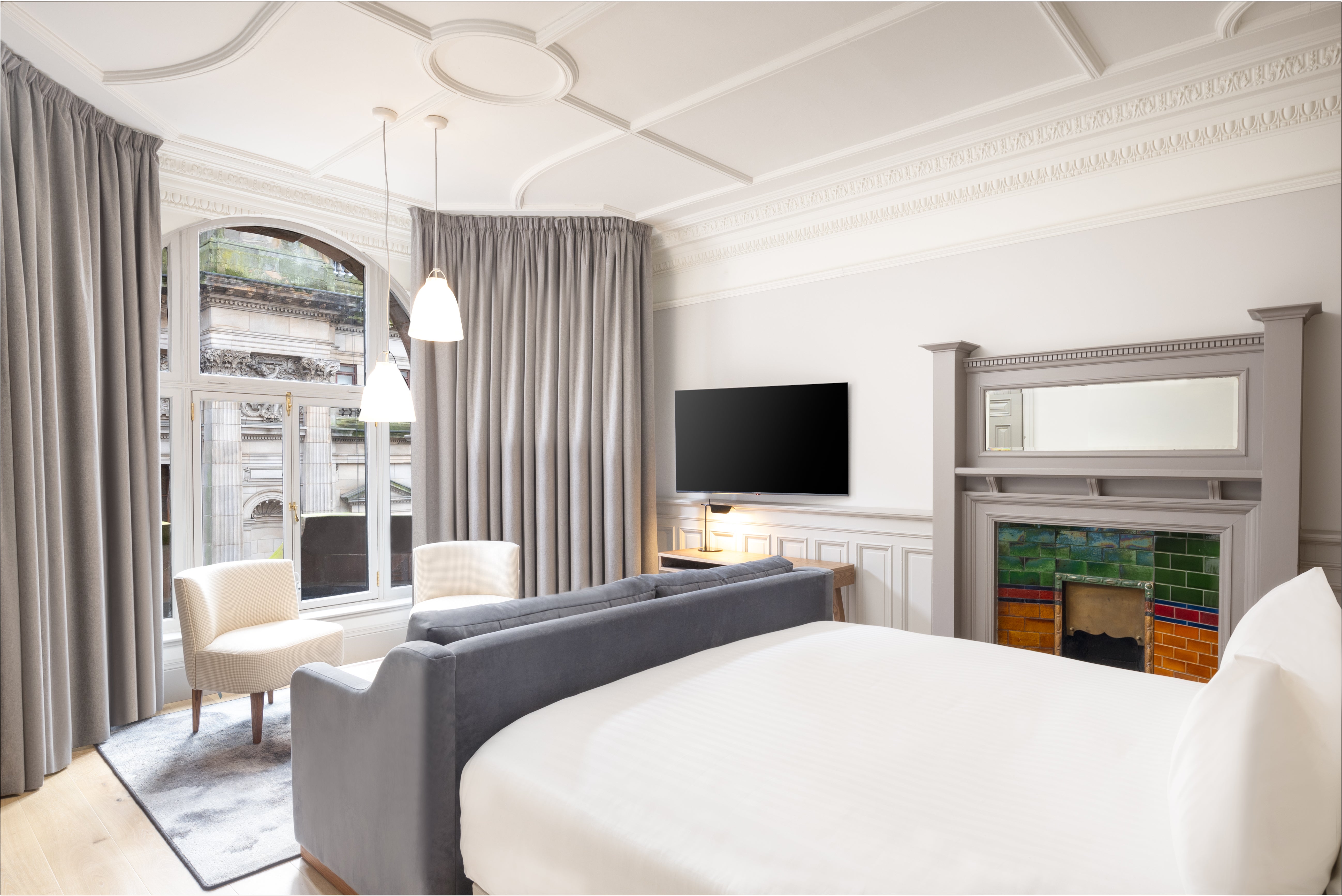 Floor-to-ceiling windows will allow you to take in all of George Square from the comfort of your AC Hotel bedroom