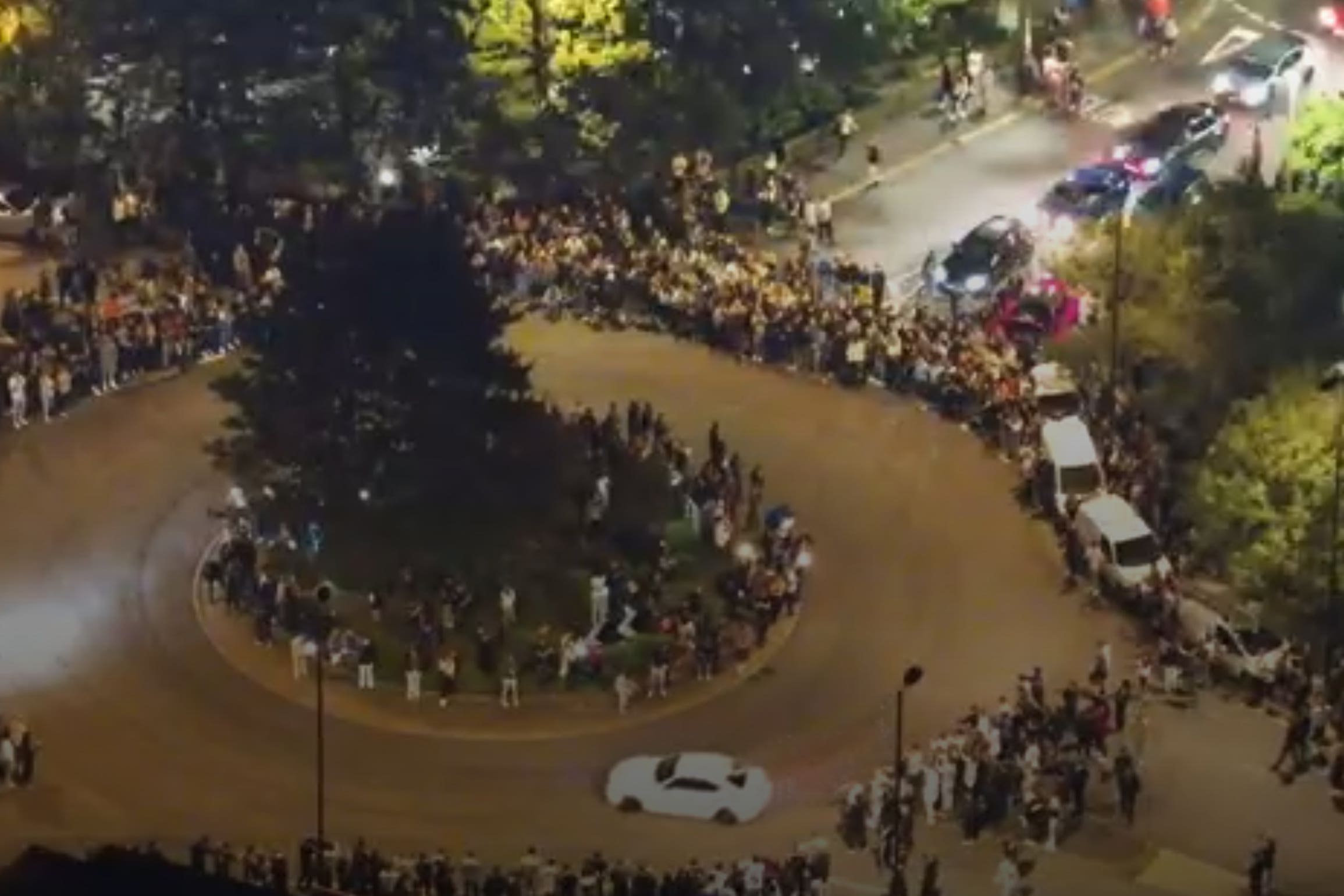 <p>Screen grab of CCTV footage showing Toby Clarkson driving his white BMW dangerously at a car meet in Southampton (Hampshire Constabulary/PA)</p>