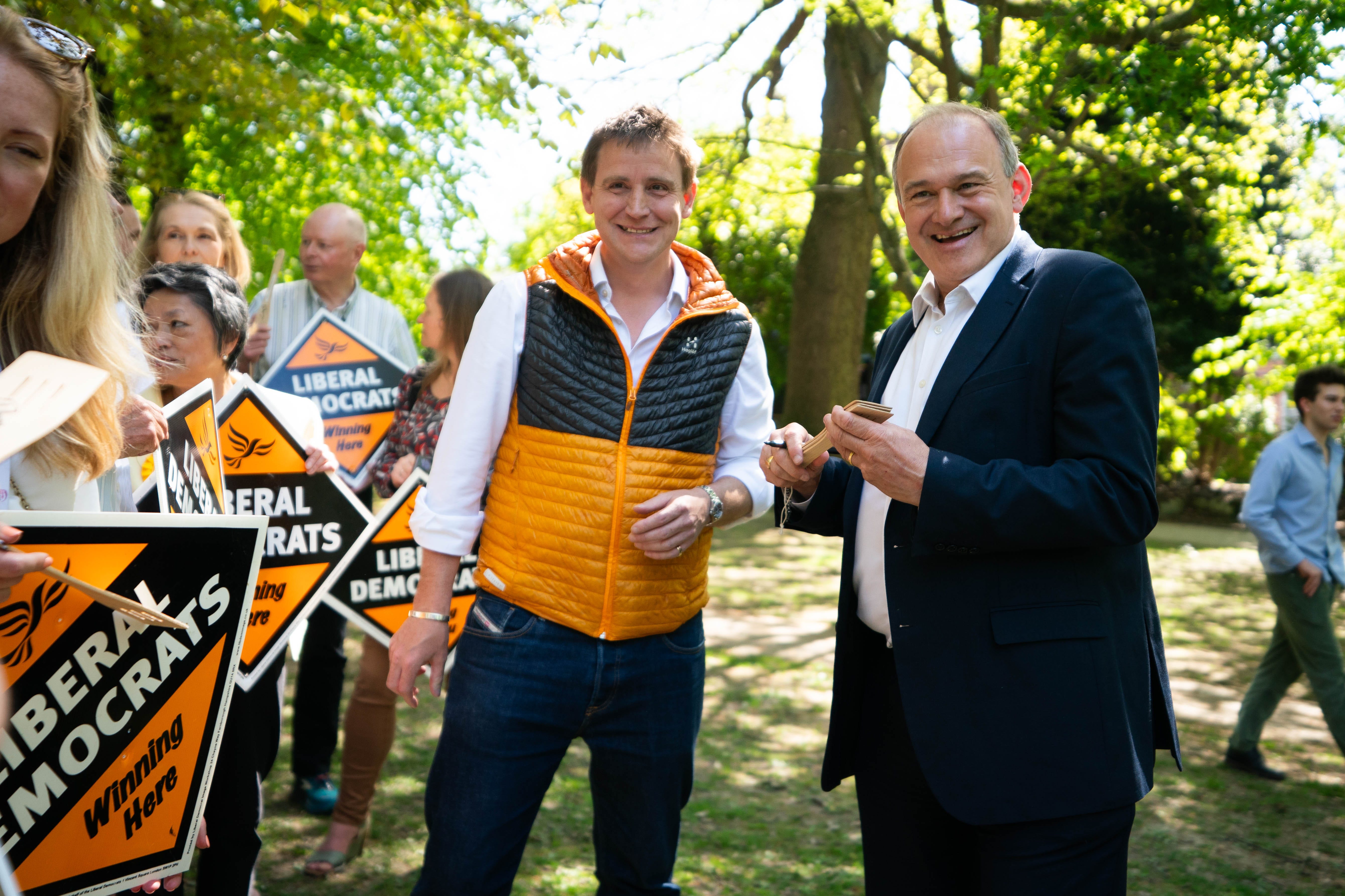 Liberal Democrat Leader Sir Ed Davey signs spatulas, with MP Mike Martin, (left) in Grove Park, Royal Tunbridge Wells (James Manning/PA)